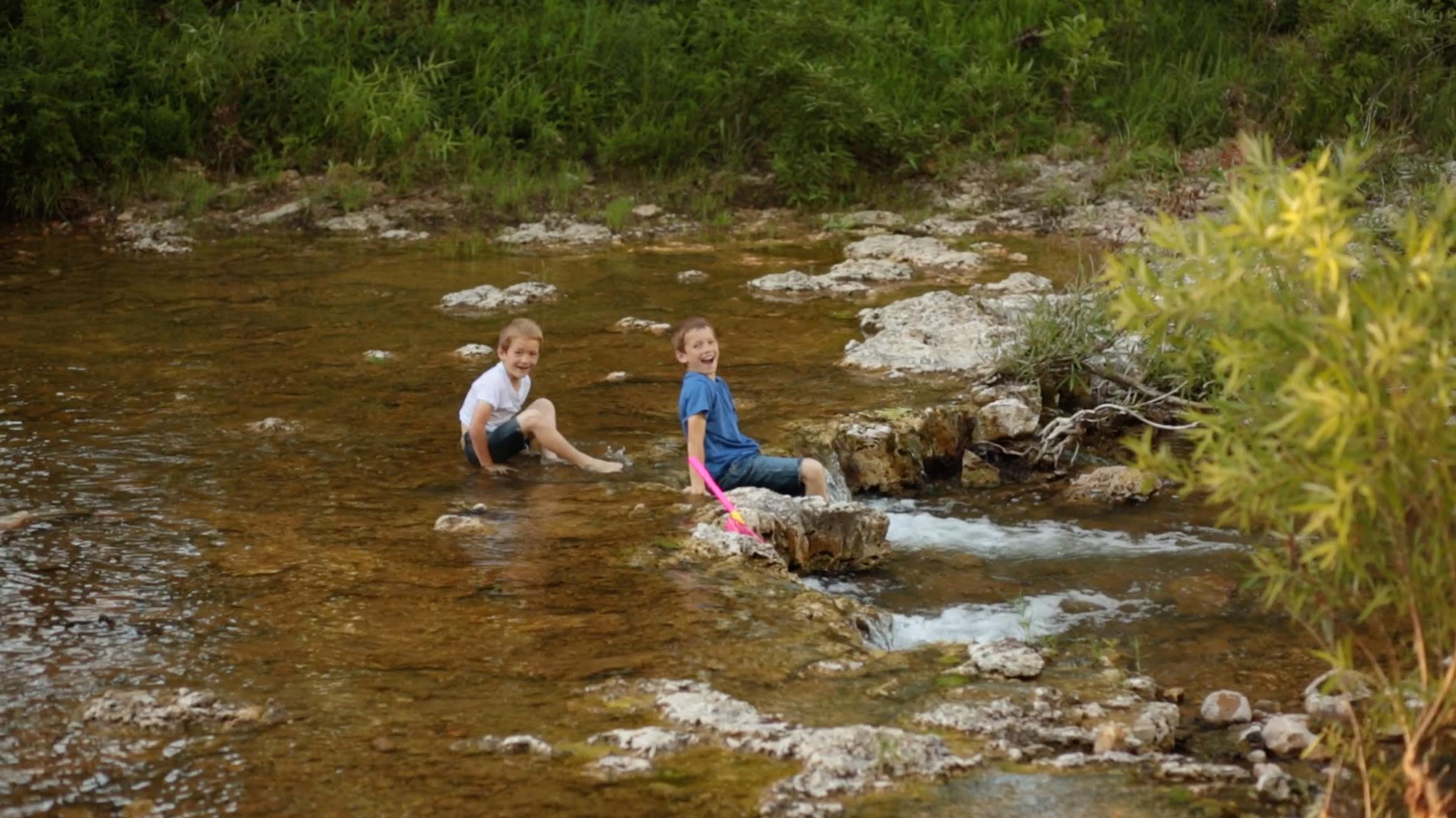 Kids playing in stream